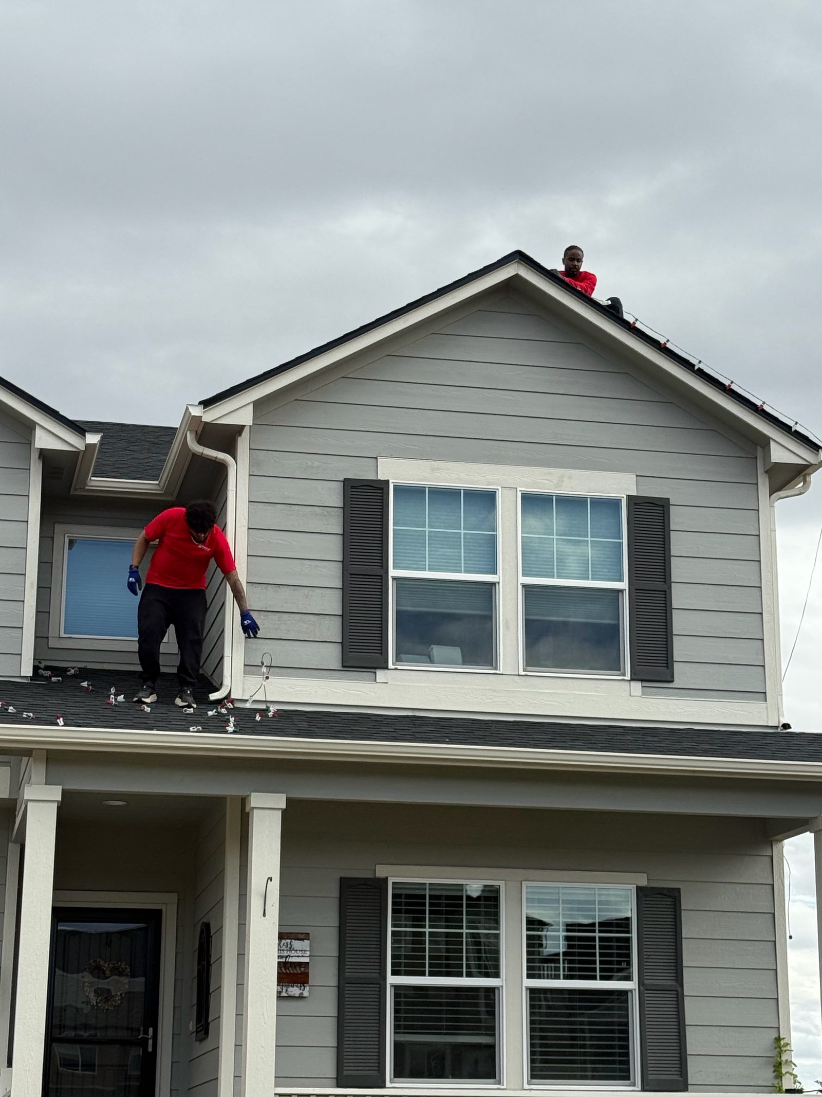 Professional Christmas light installation crew on roof installing LED lights on the Front Range Professional Christmas light installation crew on roof installing LED lights on the Front Range