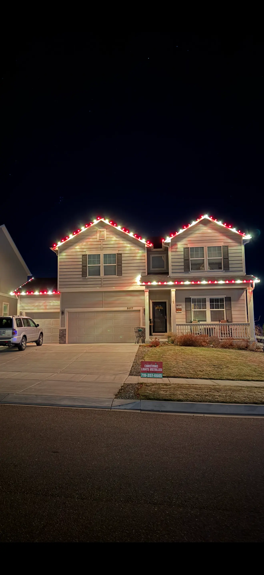 Red and white LED roofline on a two-story home — Front Range portfolio install